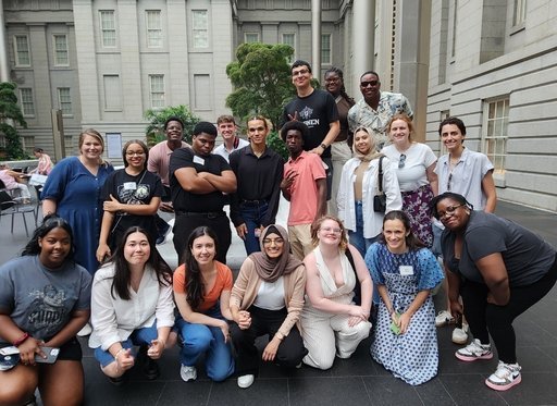 Numerous PAYA Youth Council members pose at a museum.