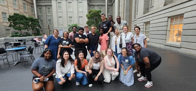 Numerous PAYA Youth Council members pose at a museum.