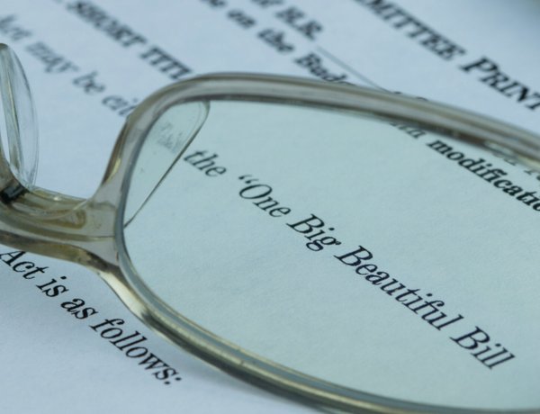 A pair of glasses rests on a Big Beautiful Bill